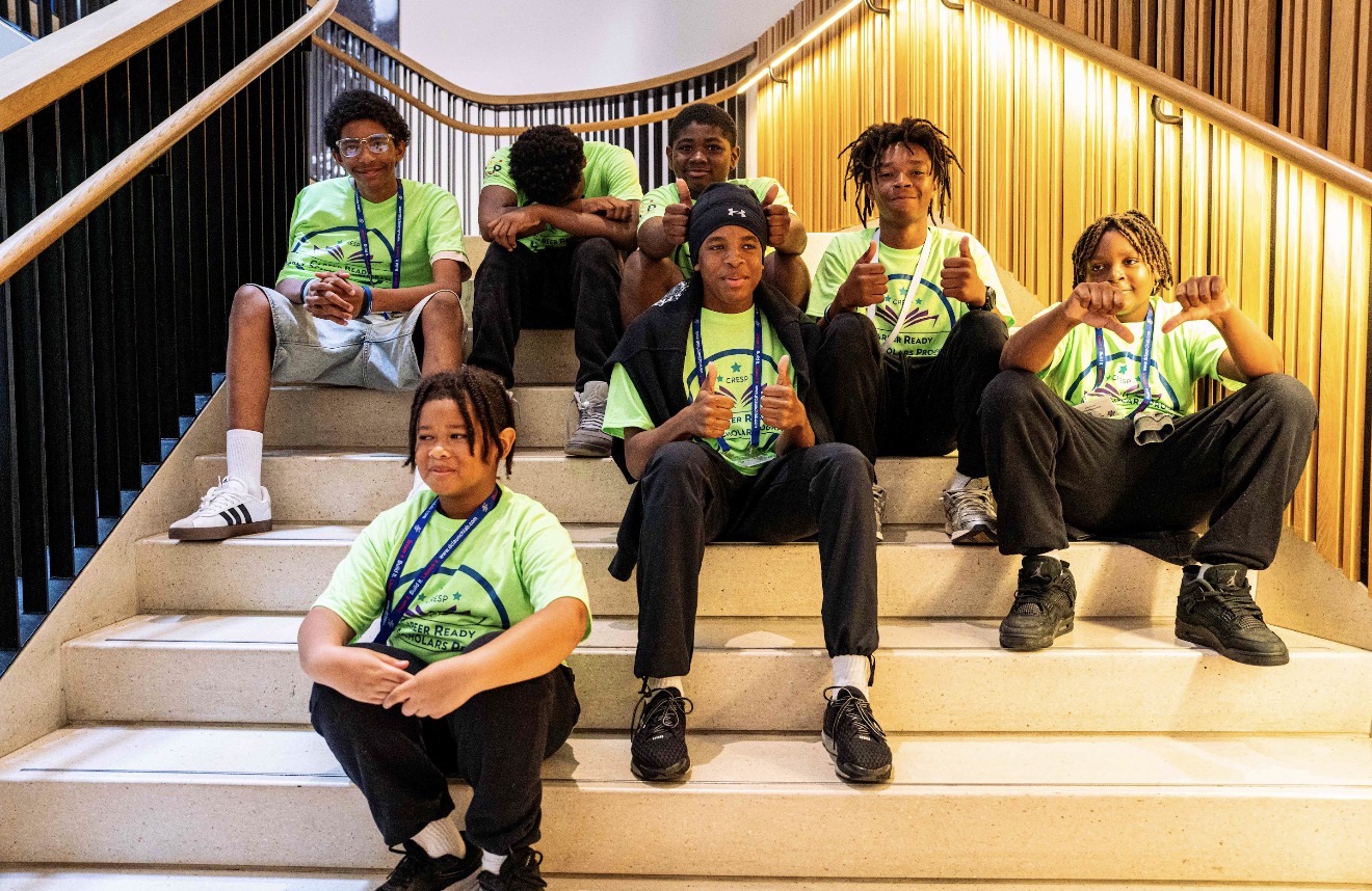 Scholars posing together on the MLK Library stairs