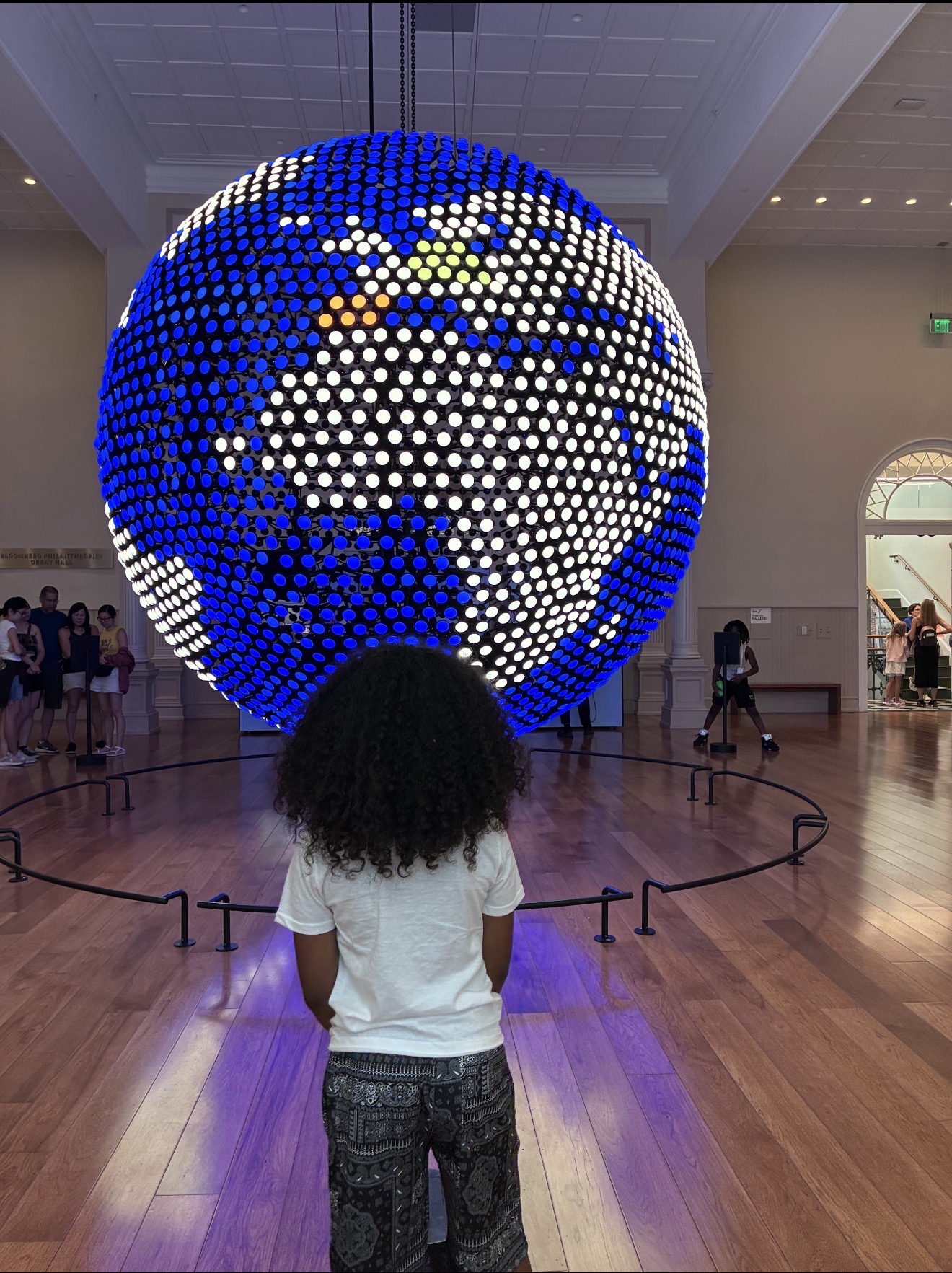 Scholars at the Planet Word globe installation